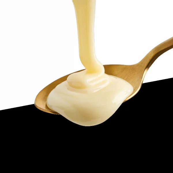 condensed milk pouring into spoon