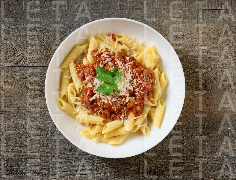 bowl of pasta penne with sauce bolognese