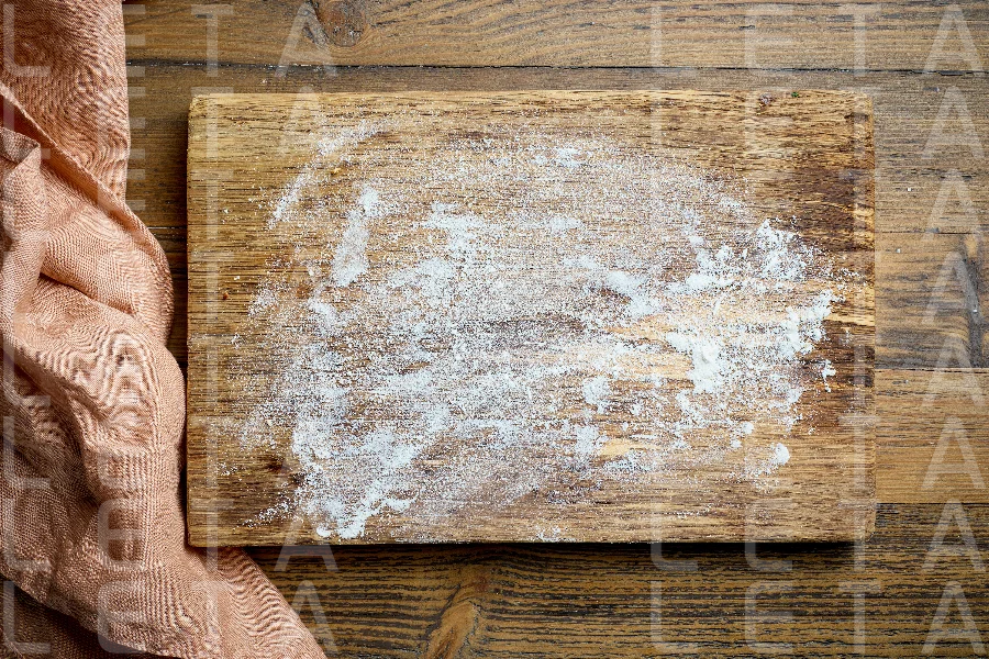 flour on wooden cutting board