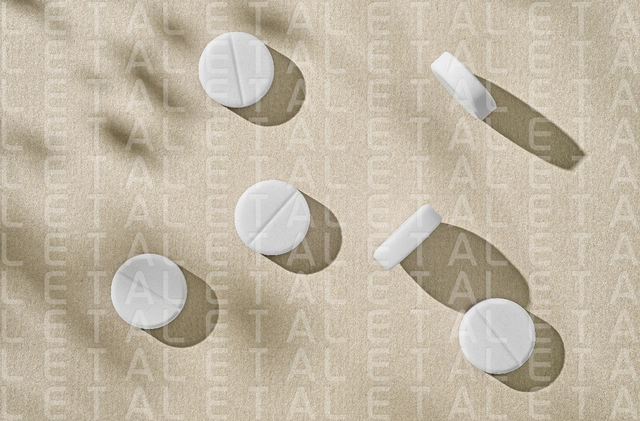white pills on beige background