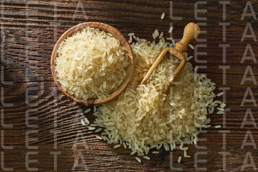 raw rice in wooden bowl and spoon