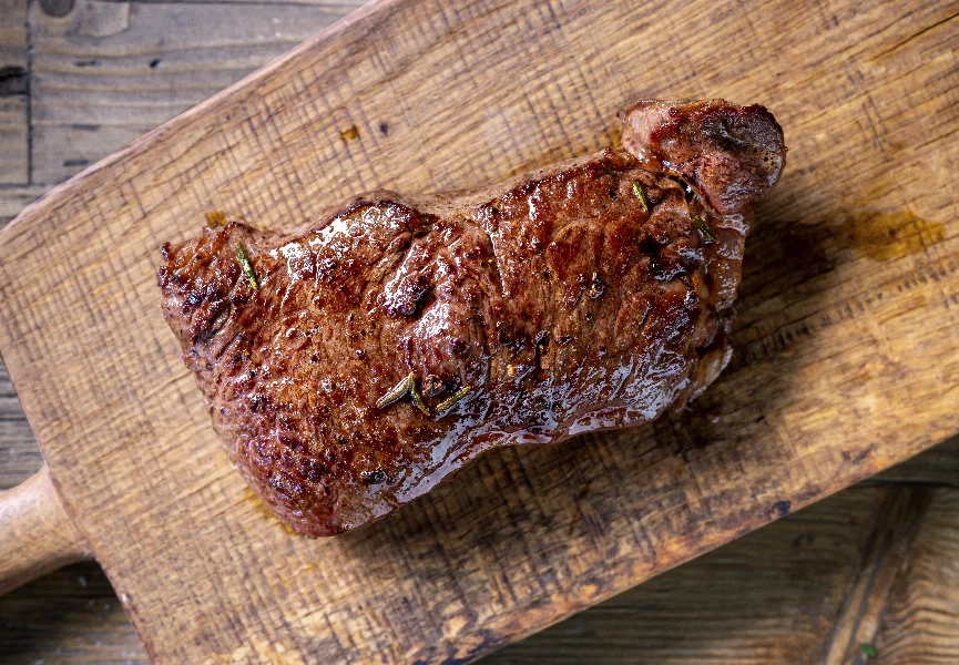 fresh grilled beef steak meat with salt and pepper on wooden cut