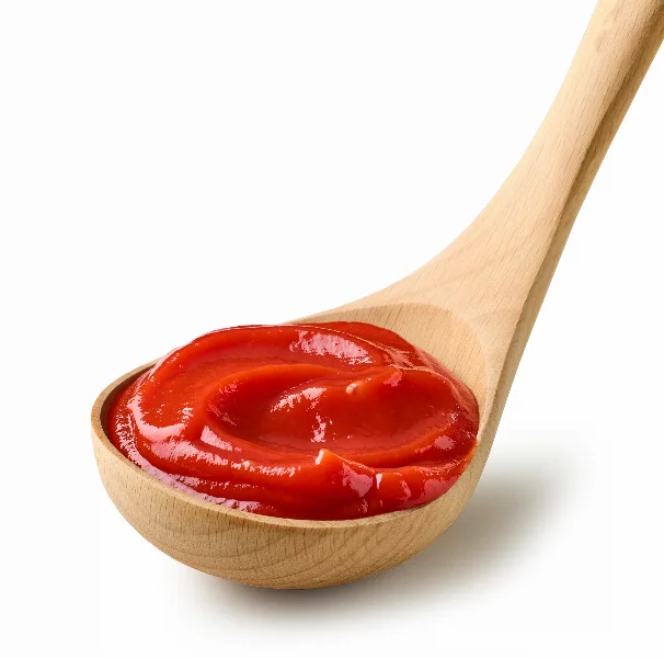 tomato sauce ketchup in wooden ladle